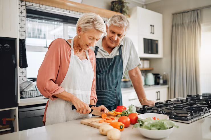 senior-couple-healthy-food-cooking-lunch-together-australia-kitchen-home-happy-woman-hungry-man-retirement-people-cut-vegetables-nutrition-diet-wellness-vegan-dinner-meal_590464-89837